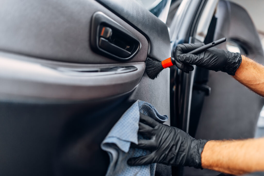Detailing expert from Nearby Auto Detail providing premium service on a vehicle in Cascade, Michigan.